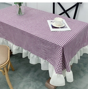 Detail of purple and white checkered tablecloth with decorative white ruffle edges