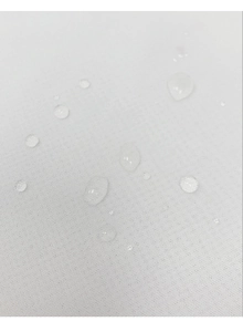 Macro shot of waterproof white outdoor curtain fabric showing water-repellent droplets