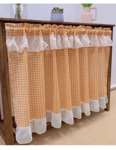 Detail view of American style yellow and white checkered cafe curtain with lace ruffle edge