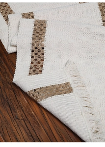Detailed macro view of woven cotton linen table runner with fringes and textured stripes