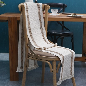 Two-tone woven cotton linen table runner with brown stripes and decorative fringe edges