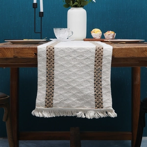 Bohemian off-white cotton linen table runner with tassel accents and diamond weave pattern