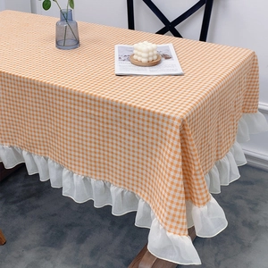 Orange and white gingham tablecloth with ruffled lace edges for dining tables