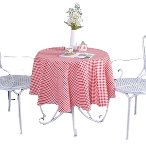 Nordic red and white gingham round tablecloth in cotton linen on a white iron table