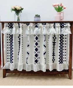Detail of bohemian cafe curtain featuring navy geometric prints and double ruffle lace trim