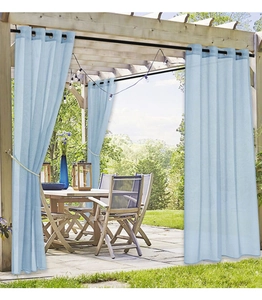 Light blue outdoor sheer curtains with grommet top hanging on a wooden pergola