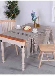 Detailed texture of brown and white checkered cotton linen tablecloth on a dining table