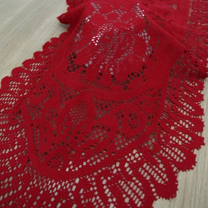 Red crochet lace table runner with intricate hollow floral patterns for festive home decor