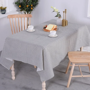 Minimalist grey and white gingham checkered tablecloth in a cozy home dining setting