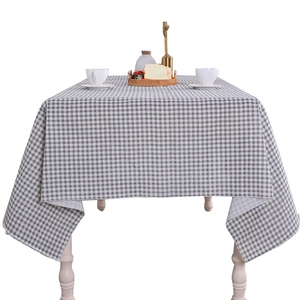 Minimalist grey and white checkered linen tablecloth with natural drape on a square table