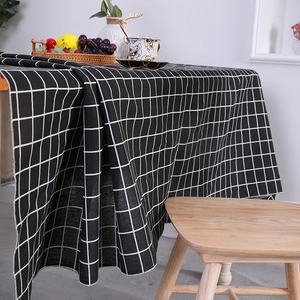 Minimalist black and white plaid cotton linen tablecloth on a rustic wooden dining table