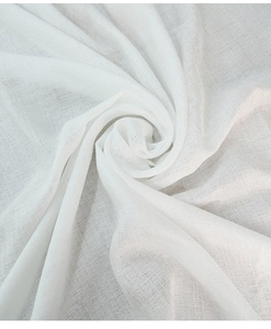 Detail of white Nordic linen tablecloth showing soft fabric texture and elegant lace edge