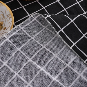 Minimalist black and white plaid linen tablecloth with detailed stitching for home dining décor