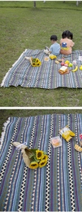 Detailed view of Bohemian style picnic mat with tassels and colorful woven patterns