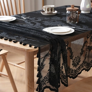 Elegant black lace tablecloth with floral hollow patterns and fringe tassels for home decor