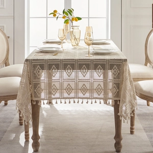 Beige crochet lace tablecloth with geometric hollow patterns and tassel edges for dining table