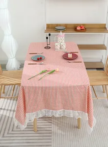 Detail of pink plaid cotton linen tablecloth with delicate white lace trim edges