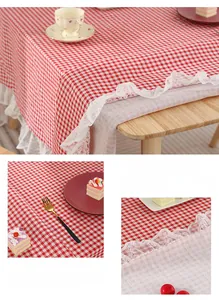 Detail of red and white checkered tablecloth with white wavy lace edging on wood table