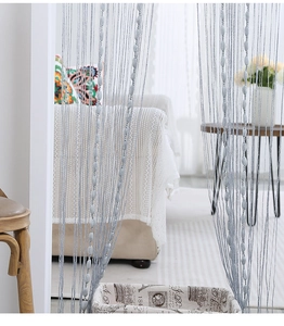 Close-up of silver tassel string curtain with matching oval beads for home decor