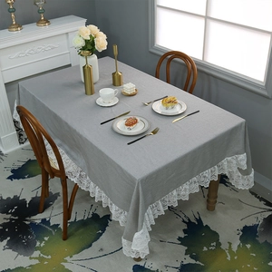 Grey cotton linen tablecloth with white lace edges for a rustic rectangular dining table
