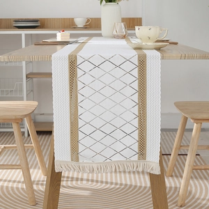 Detailed macro view of hollow diamond woven texture and tassel fringe on table runner