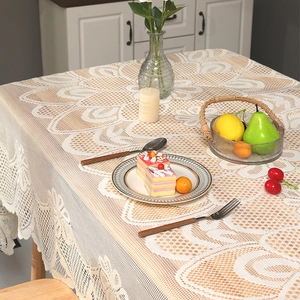 Vue détaillée d'une nappe en dentelle crème avec jacquard floral et bord festonné