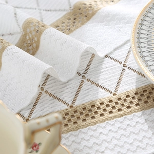 Elegant white woven table runner with diamond patterns in minimalist Nordic retro style