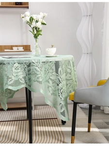 Close-up of light green lace tablecloth with exquisite floral hollow weave texture