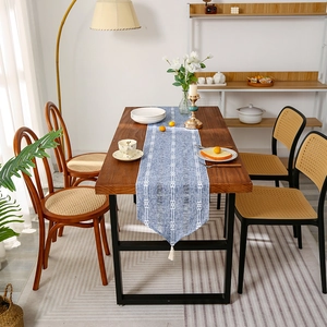 Blue cotton linen table runner with white geometric patterns and tassel fringe decor