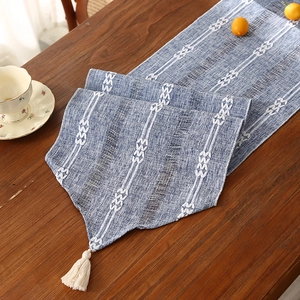 Blue and white woven cotton linen table runner with embroidery and tassel fringe details