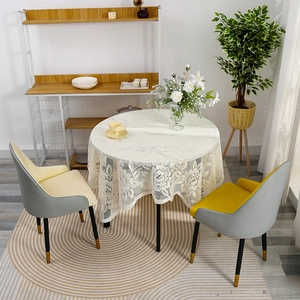 Elegant white lace round tablecloth with floral cutout patterns and wavy edges for dining