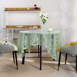 Mint green round lace tablecloth with floral hollow embroidery in a modern home setting