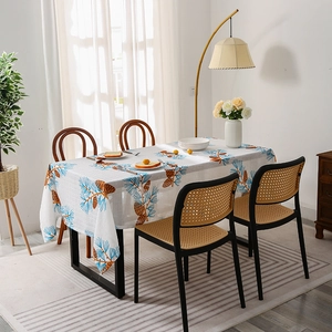 Nordic oil-proof tablecloth featuring blue pine needles and cones on white fabric