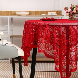 Elegant red lace tablecloth with floral patterns on a round table for home decor