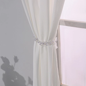 Lavender faux pearl bead curtain tieback with floral design on beige textured curtains