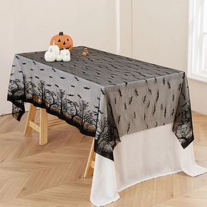 Halloween black lace tablecloth with bats and dead trees design over white cloth