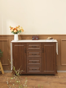 Detail view of vintage dark walnut wood sideboard with four drawers and side cabinets