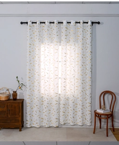 Detail of white blackout curtains with gold feather patterns and metal grommet top