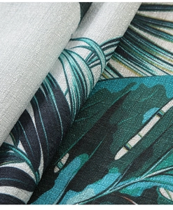 Macro shot of tropical leaf print on linen table cloth showing fabric texture and weave