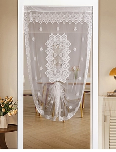 Detailed white lace curtain featuring floral embroidery and elegant scalloped hem design