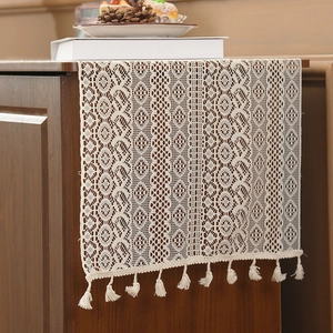 Vintage beige crochet lace table runner with geometric floral patterns and fringe tassels