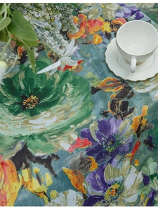Detail showing high-quality oil painting floral tablecloth with elegant ceramic teacup