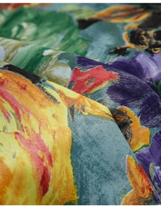 Macro shot of colorful floral print fabric showing detailed twill weave texture