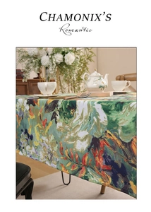 Detail of oil-proof floral tablecloth with vibrant oil painting patterns and fringe edge