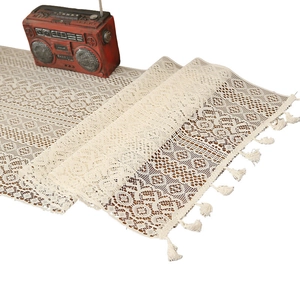 Vintage white crochet lace table runner with hollow floral pattern and fringe tassels