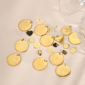 Collection of vintage gold-plated pendants including round engraved tags and heart charms