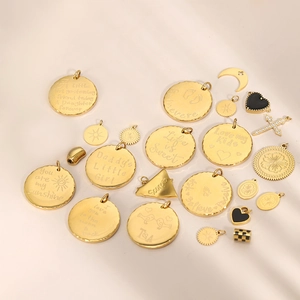 Detailed close-up of gold-plated pendant charms with engraved sentimental text and motifs