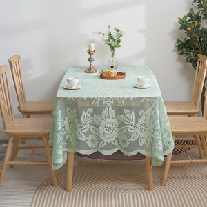 Light green lace tablecloth with rose floral patterns and elegant wavy edges