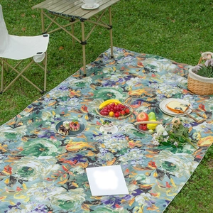 Artistic oil painting picnic mat with floral pattern on grass for outdoor gathering