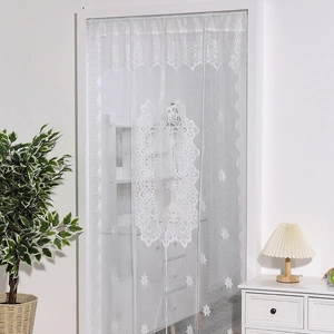 White lace door curtain with floral mesh design in a bright minimalist home setting